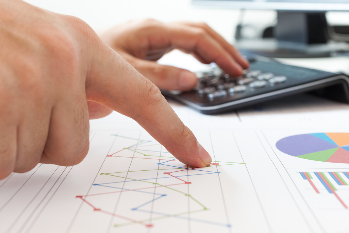 pphoto-businessman-hand-examining-financial-charts-using-calculator