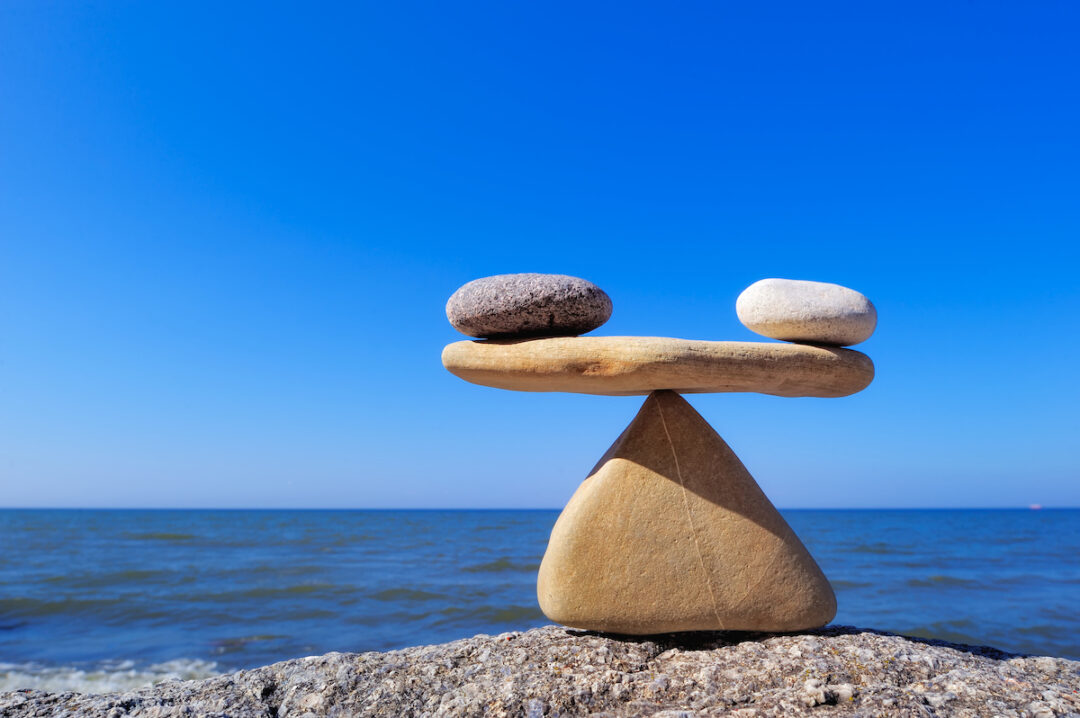stock-photo-concept-of-harmony-and-balance-balance-stones-against-the-sea-rock-zen-in-the-form-of-scales